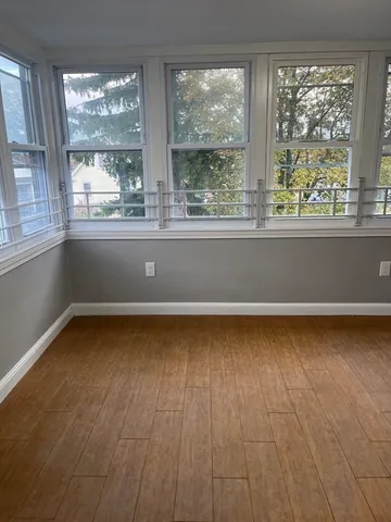 a view of a room with wooden floor and outdoor view
