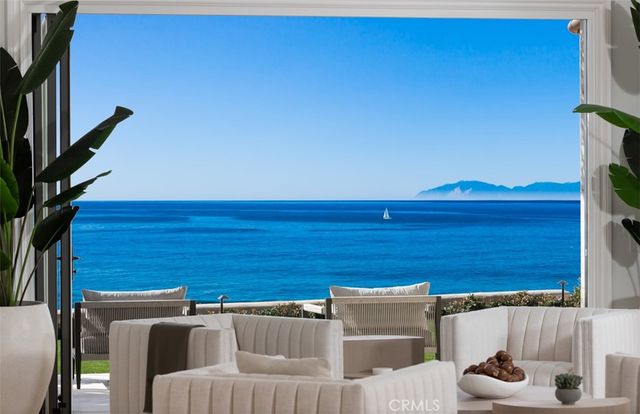 a view of a living room and a potted plant in a room