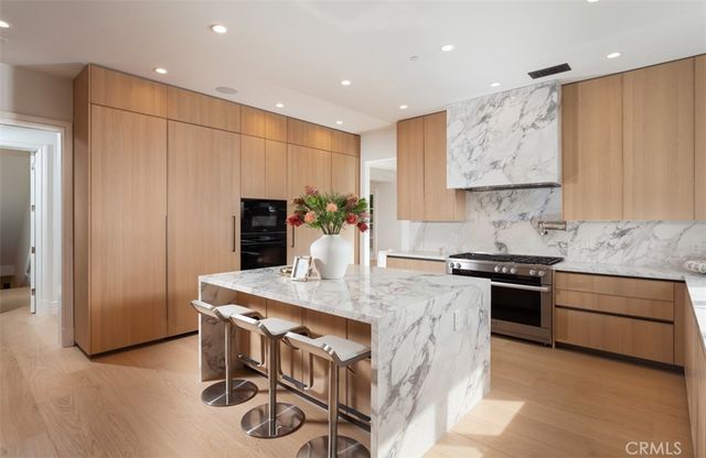 a spacious bedroom with a bed and a potted plant