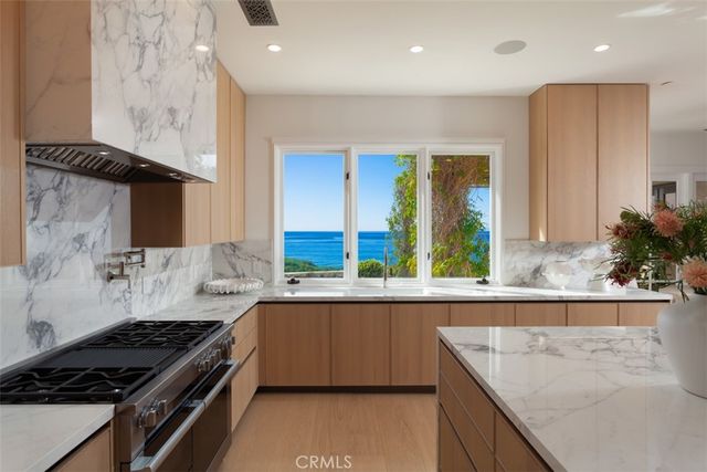 a view of a chair and table in backyard of the house