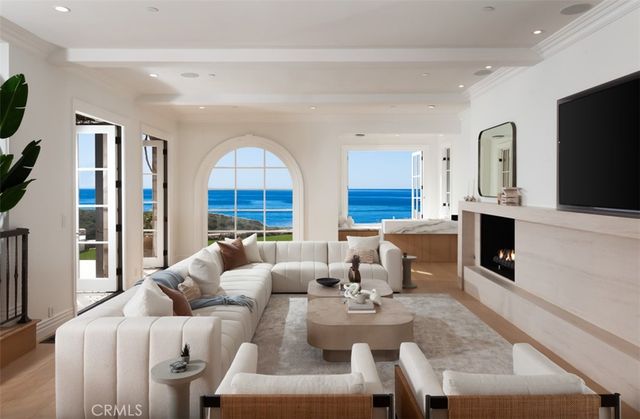 a spacious bedroom with two beds and a flat screen television