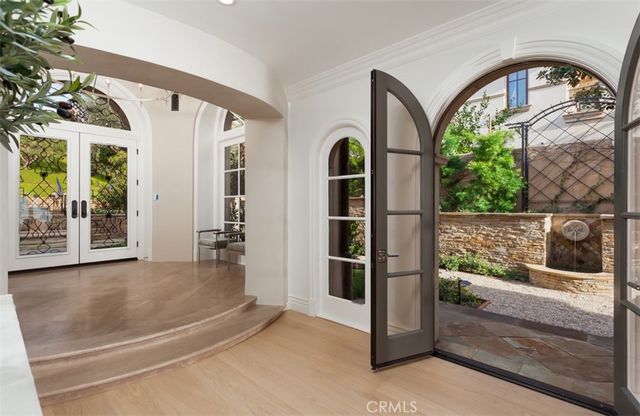 a living room with furniture a potted plant and a large window