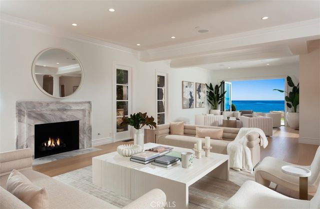 a kitchen with stainless steel appliances granite countertop a stove a sink a refrigerator and white cabinets with wooden floor