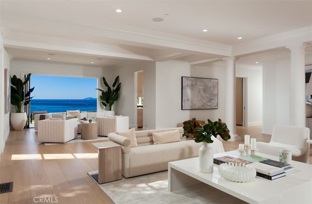 a living room with furniture a flat screen tv and a large window