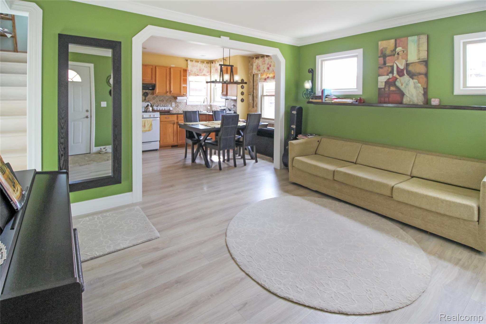 5953 Cooper Street Taylor, MI 48180 - Photo 3 of 33 Open-concept living space featuring light wood-finish flooring, white trim, and direct access to the kitchen and dining area