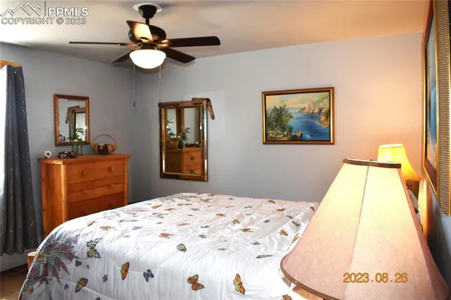 a bedroom with a bed and a mirror