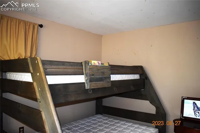 a view of a roof deck with table and chairs with wooden floor and fence