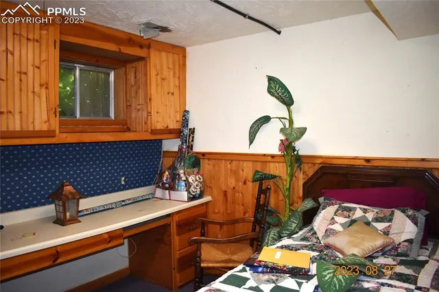 a view of a patio with wooden floor table and chairs