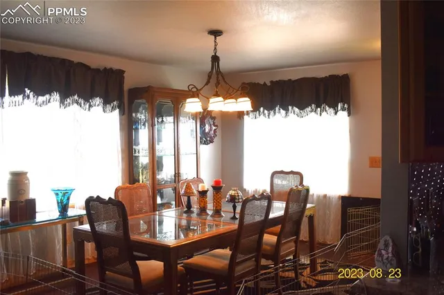 a kitchen with granite countertop a stove a sink and a wooden cabinets