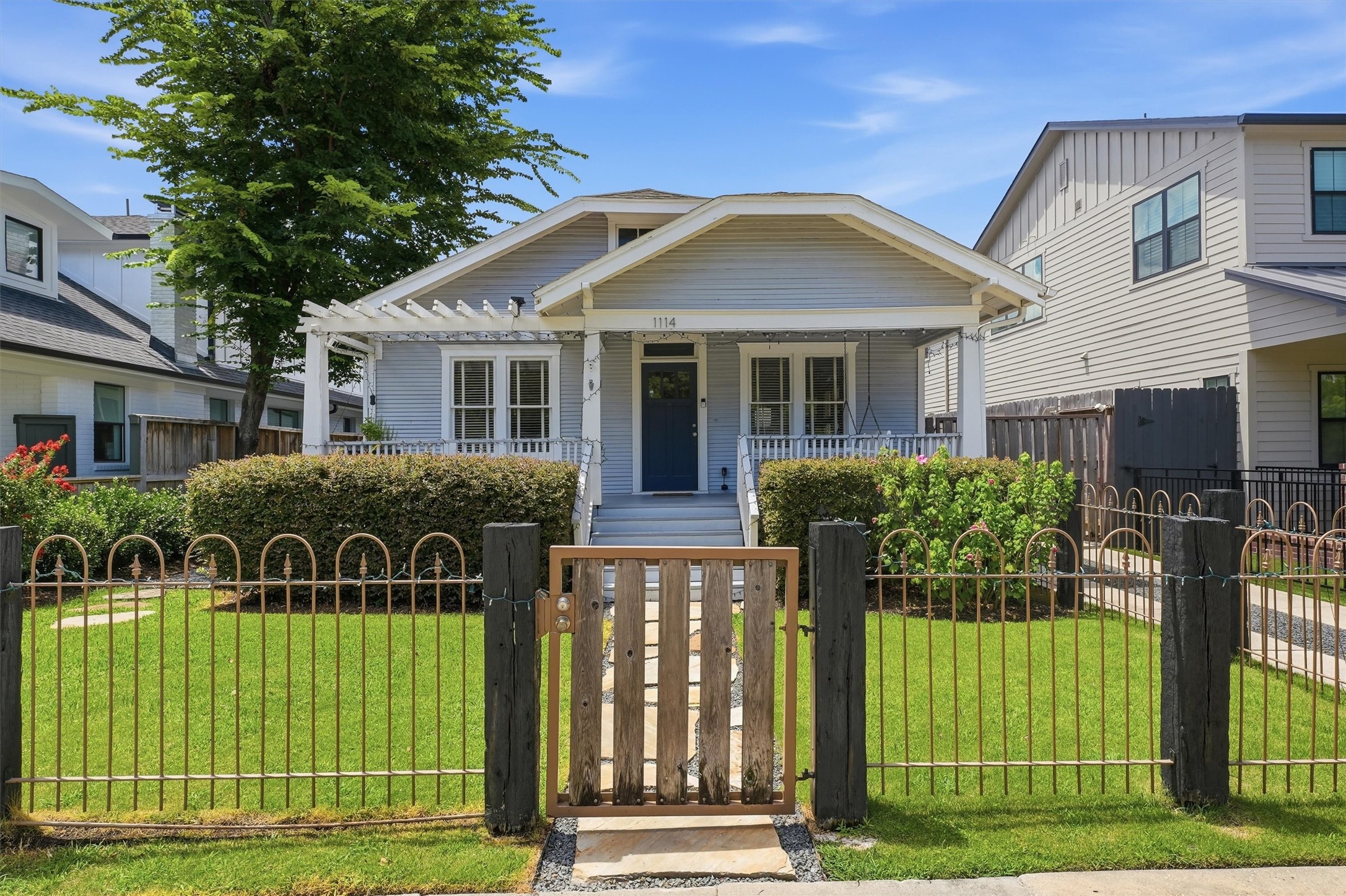 1114 Merrill Street Houston, TX 77009 - Photo 1 of 34 Bungalow charm with covered porch, fenced front yard, pergola, and landscaped walkway to entry.