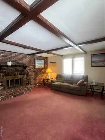 a living room with furniture a window and a fireplace