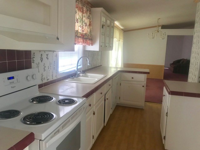 771 Hyde Road Northwest Resaca, GA 30735 - Photo 9 of 27 a kitchen with a sink a stove and cabinets