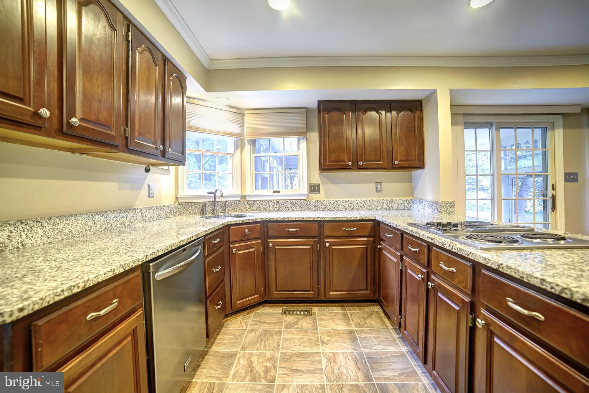 9520 Stoneoak Road Baltimore, MD 21236 - Photo 3 of 26 a large kitchen with granite countertop lots of counter space and a sink