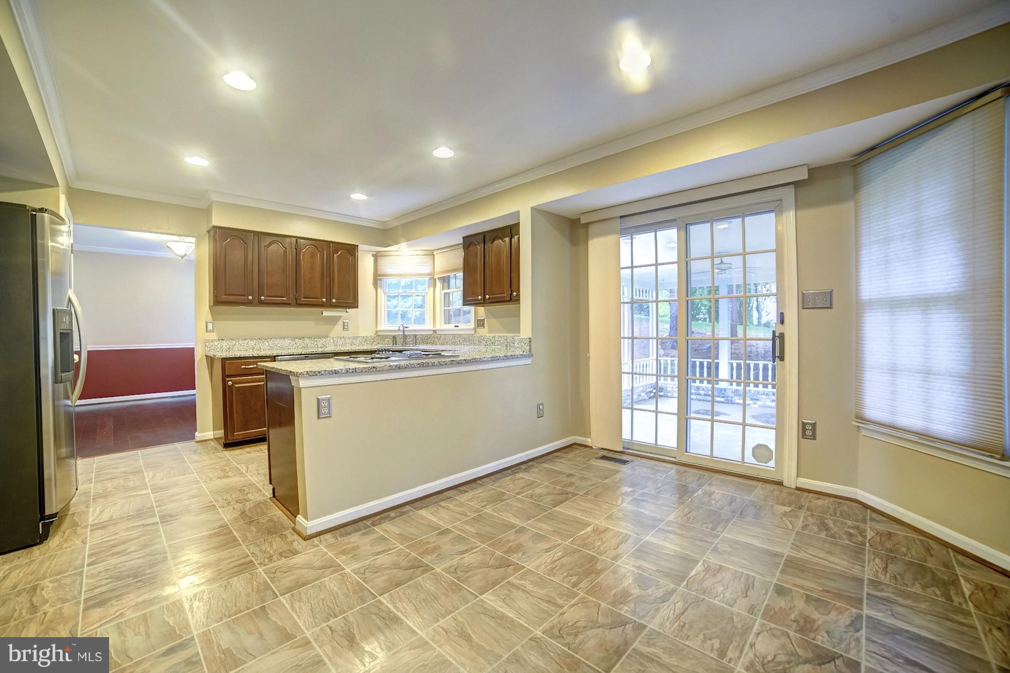 9520 Stoneoak Road Baltimore, MD 21236 - Photo 4 of 26 a kitchen with a stove a sink and a refrigerator