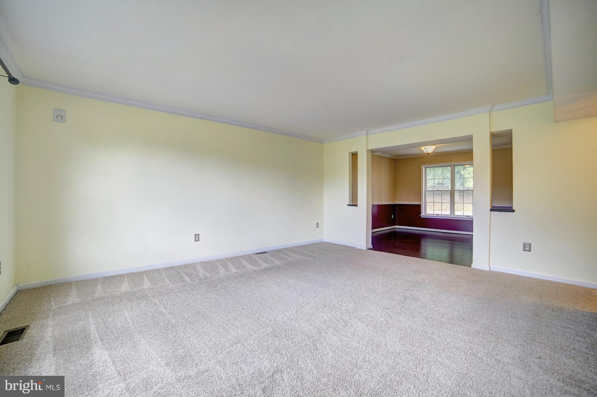 9520 Stoneoak Road Baltimore, MD 21236 - Photo 8 of 26 an empty room with windows and cabinet