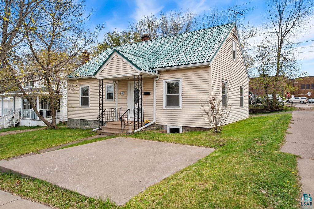 122 3rd Street Cloquet, MN 55720 - Photo 1 of 42 Exterior featuring light-colored siding and a green tiled roof