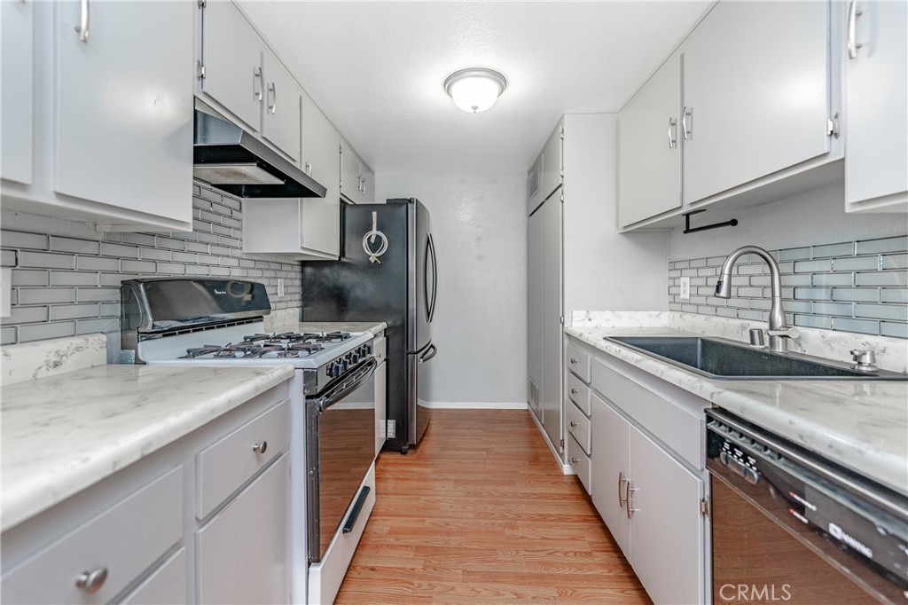 1800 East Old Ranch Road, Unit 163 Colton, CA 92324 - Photo 1 of 1 a kitchen with stainless steel appliances granite countertop a sink and a stove