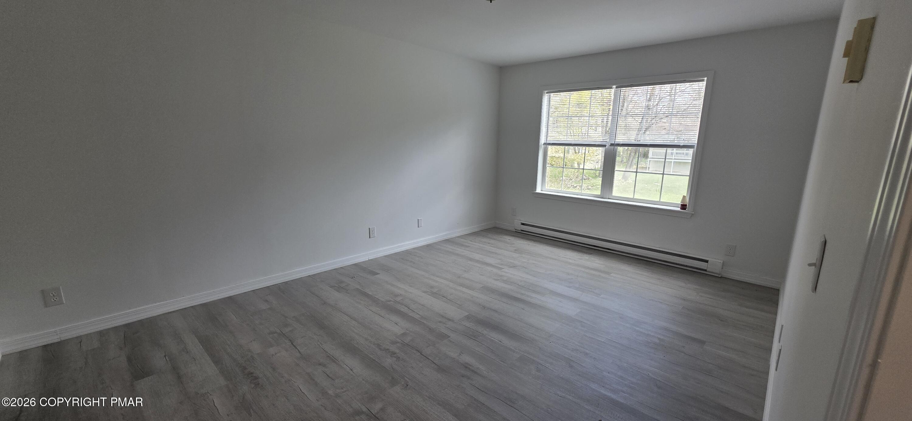 4715 Norwood Lane Tobyhanna, PA 18466 - Photo 7 of 14 an empty room with wooden floor and windows