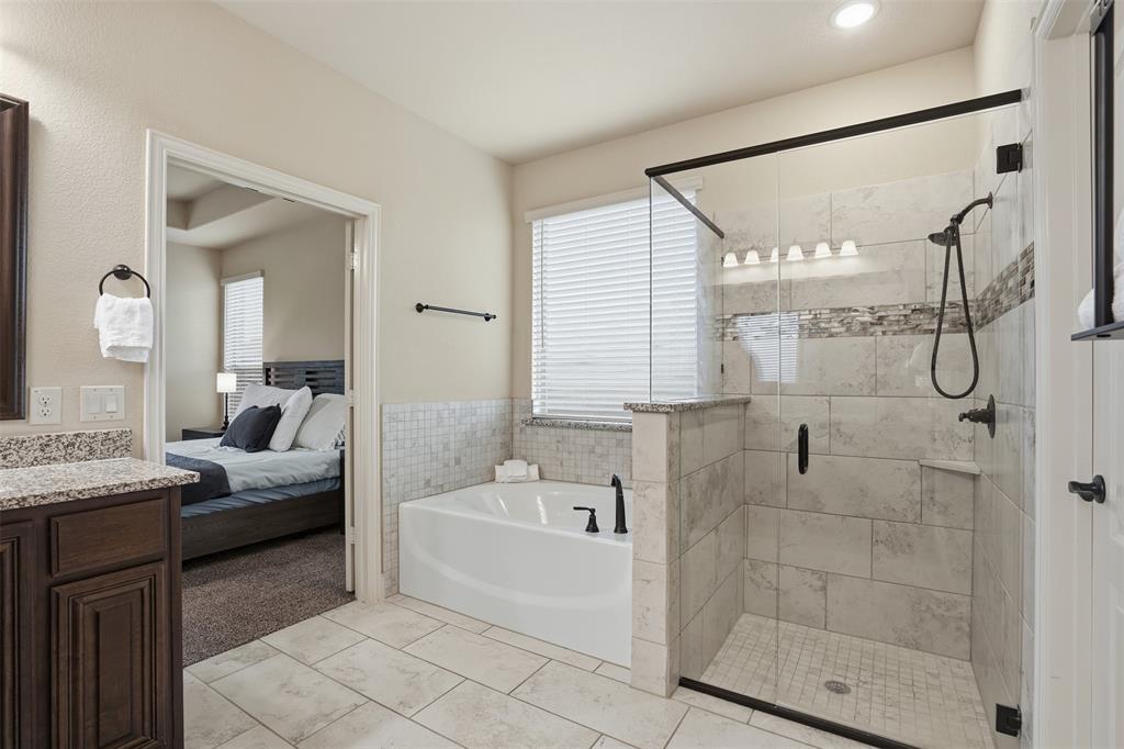 4002 Grove Valley Road Midlothian, TX 76065 - Photo 21 of 40 a en suite spacious bathroom with a granite countertop tub shower and a sink