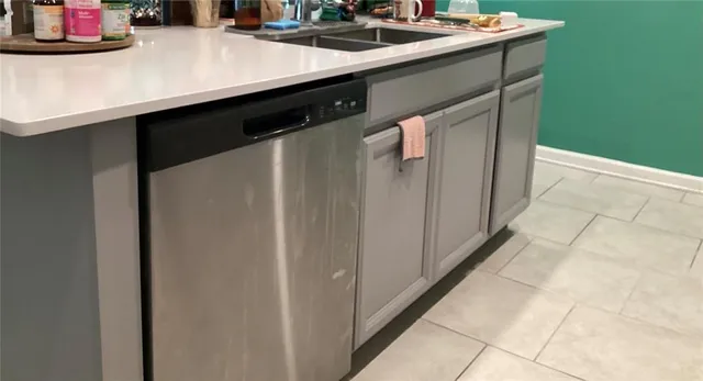 a kitchen with a sink and a refrigerator