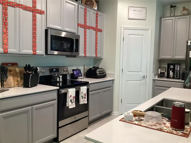 a kitchen with stainless steel appliances granite countertop a refrigerator and a stove top oven