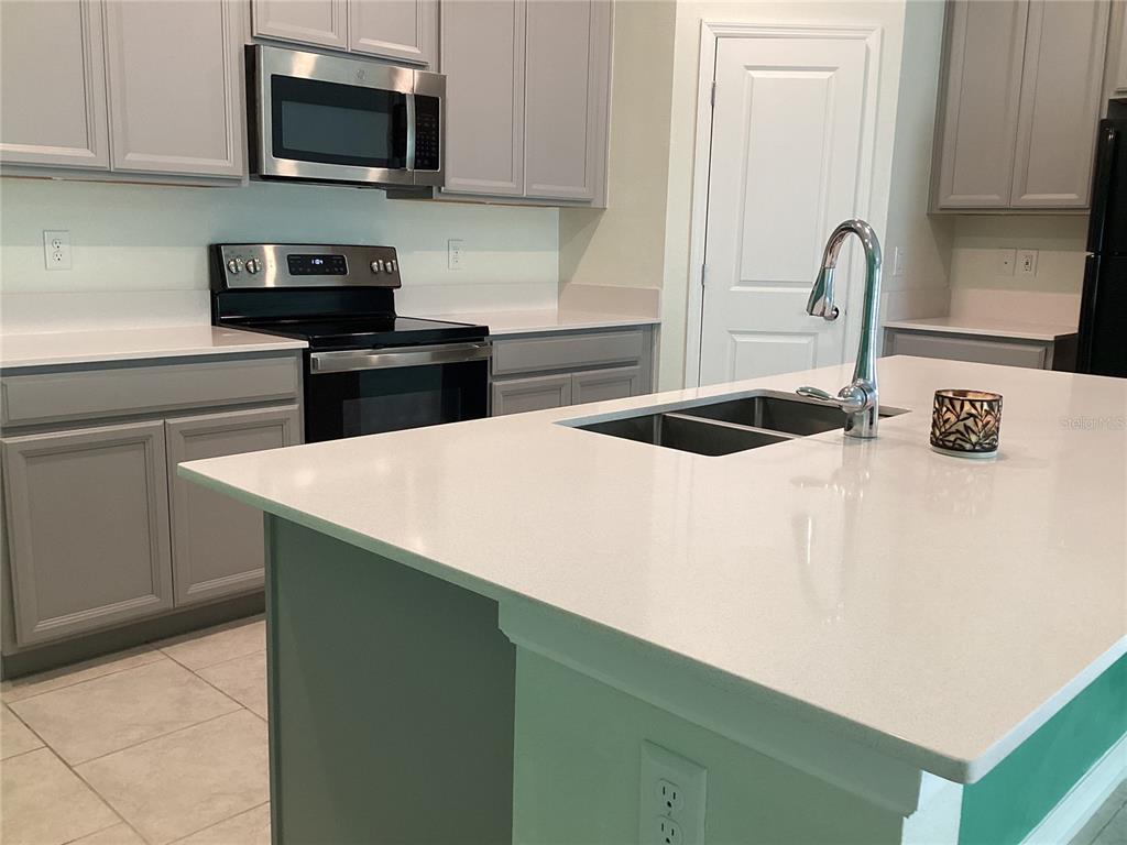 260 Pershing Street Bartow, FL 33830 - Photo 17 of 89 a kitchen with stainless steel appliances a sink a stove top oven a counter space and cabinets