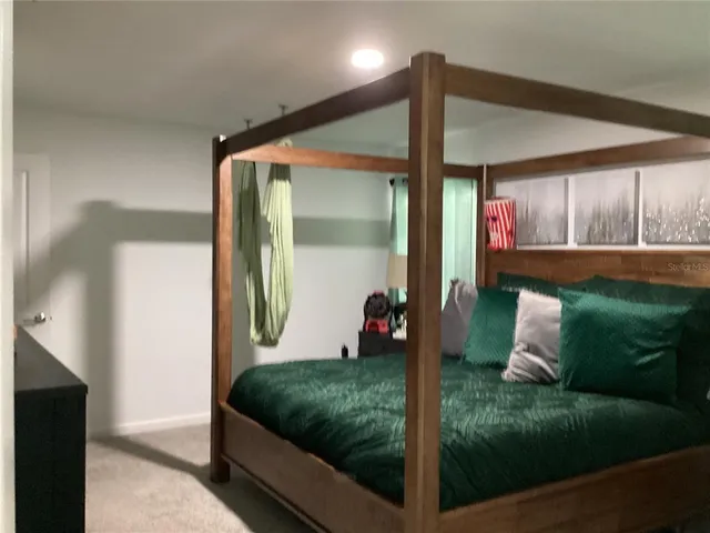 a bedroom with bed and window