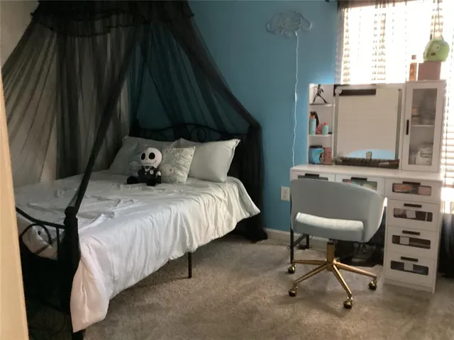 a bedroom with a bed and a chair