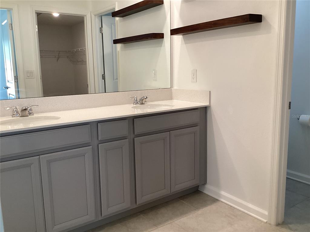 260 Pershing Street Bartow, FL 33830 - Photo 37 of 89 a bathroom with a double vanity sink and a mirror