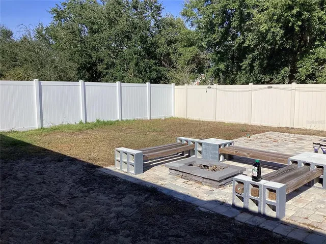 a view of a backyard with table and chairs