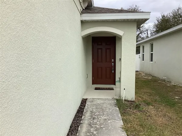 a view of kitchen with stainless steel appliances granite countertop a refrigerator and a sink