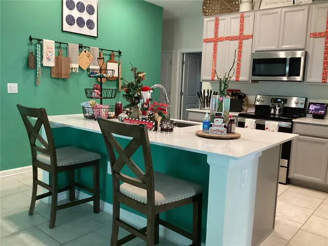 a view of a dining room with furniture and a kitchen