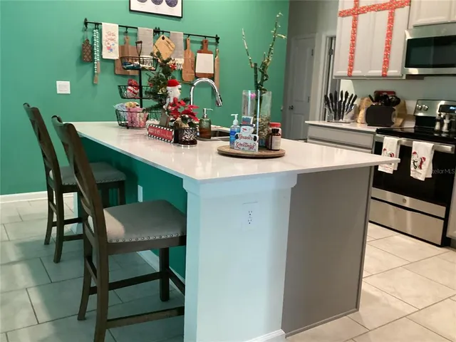 a kitchen with a table chairs and a stove