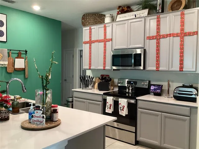 a kitchen with stainless steel appliances a sink and cabinets