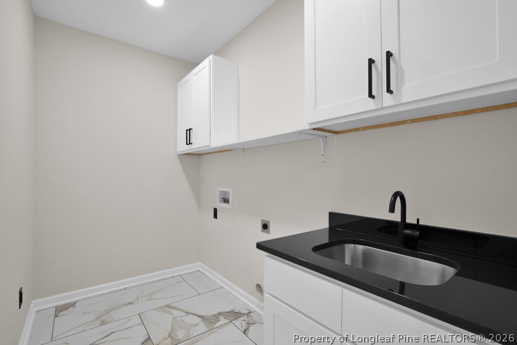 3025 Old Stage Road South Erwin, NC 28339 - Photo 27 of 50 a kitchen with granite countertop white cabinets and sink