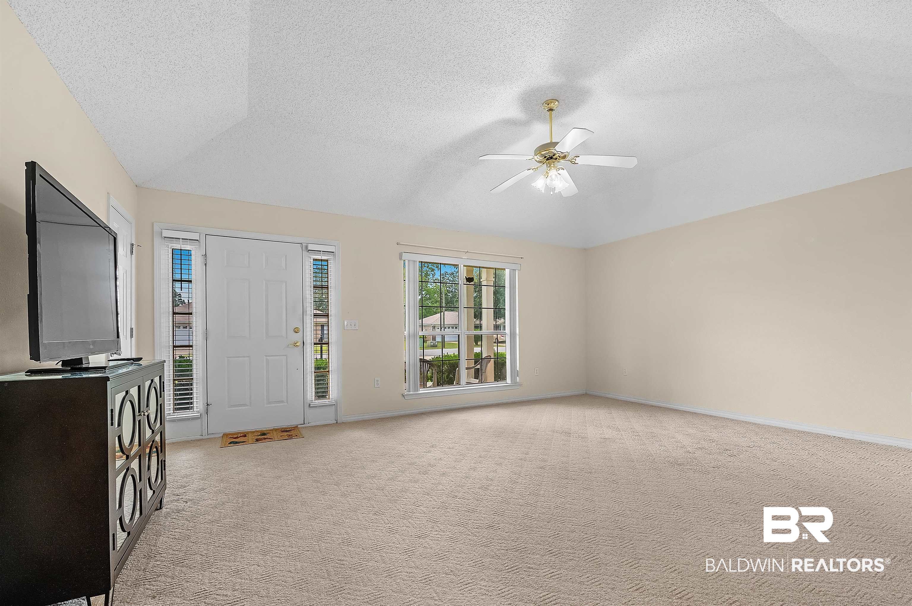 1502 Mulberry Lane Foley, AL 36535 - Photo 7 of 45 Interior space with a textured ceiling, light colored carpet, vaulted ceiling, and ceiling fan