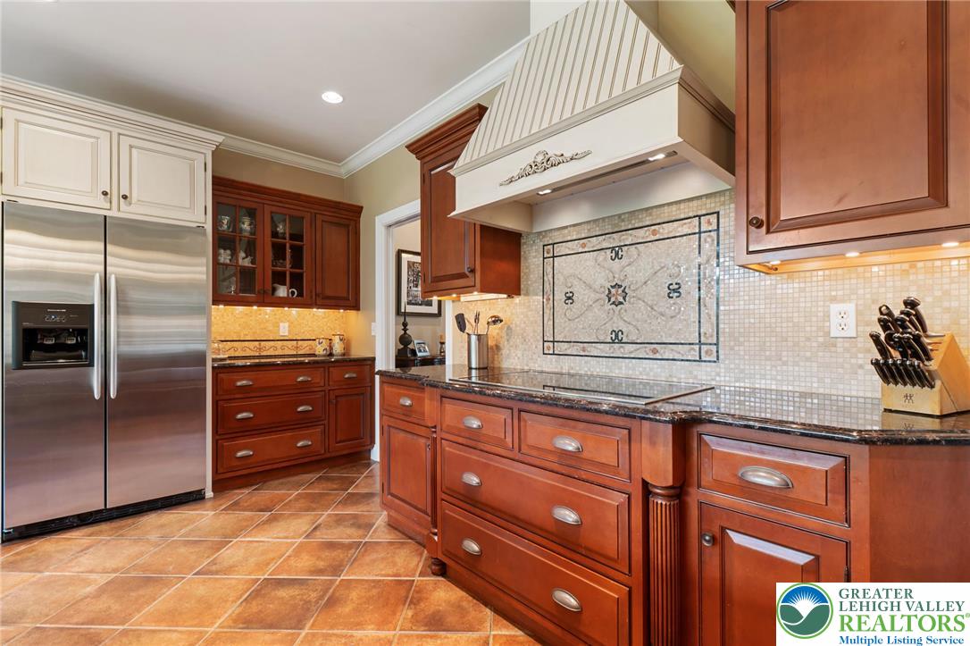 3054 Jordan Road Orefield, PA 18069 - Photo 16 of 58 a kitchen with granite countertop stainless steel appliances and wooden cabinets