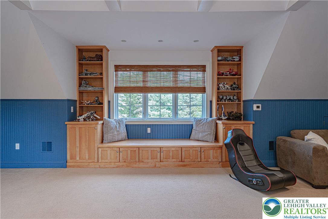 3054 Jordan Road Orefield, PA 18069 - Photo 28 of 58 a living room with furniture a floor to ceiling window and a couch