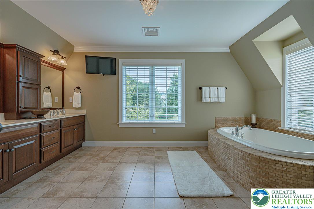 3054 Jordan Road Orefield, PA 18069 - Photo 40 of 58 a spacious bathroom with a tub sink and mirror