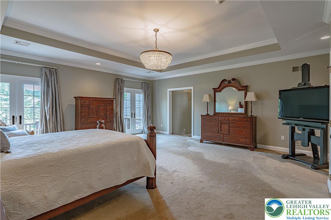 3054 Jordan Road Orefield, PA 18069 - Photo 43 of 58 a spacious bedroom with a bed and a flat screen tv