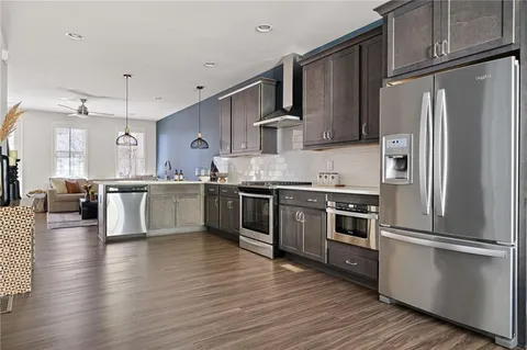 a kitchen with stainless steel appliances and wooden cabinets