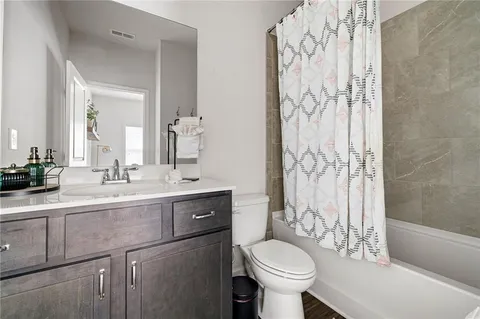 a bathroom with a sink toilet a mirror and shower