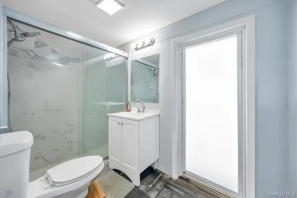 a bathroom with a sink toilet and shower