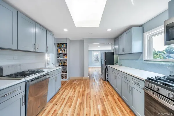 a kitchen with stainless steel appliances granite countertop a stove and a refrigerator