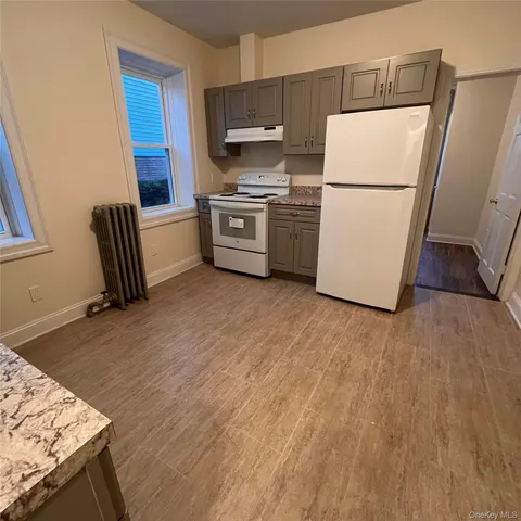 a kitchen with a refrigerator a stove top oven a sink and dishwasher