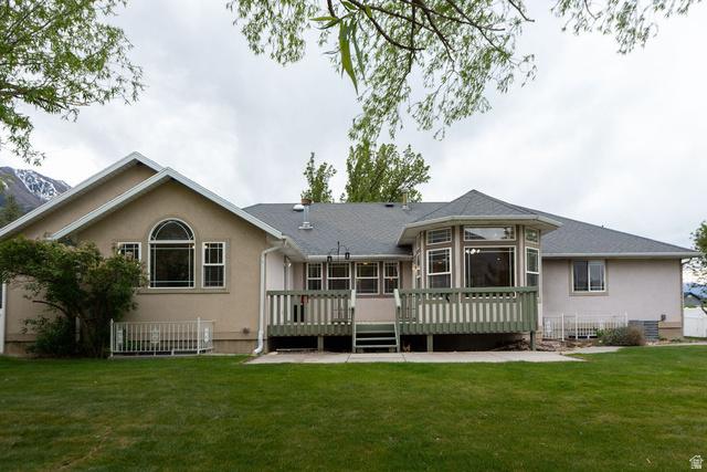 875 East 1300th Street North Mapleton, UT 84664 - Photo 49 of 65 Back of property featuring stucco siding, a deck, a yard, and roof with shingles