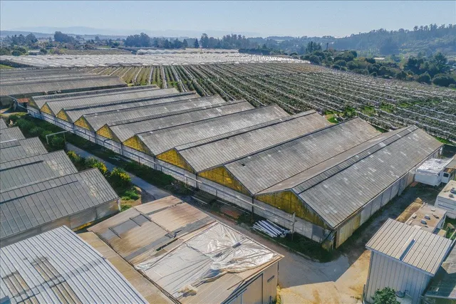 an aerial view of a house with a yard and lake view