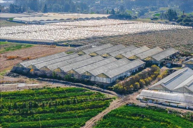 an aerial view of a house with pool outdoor seating and yard