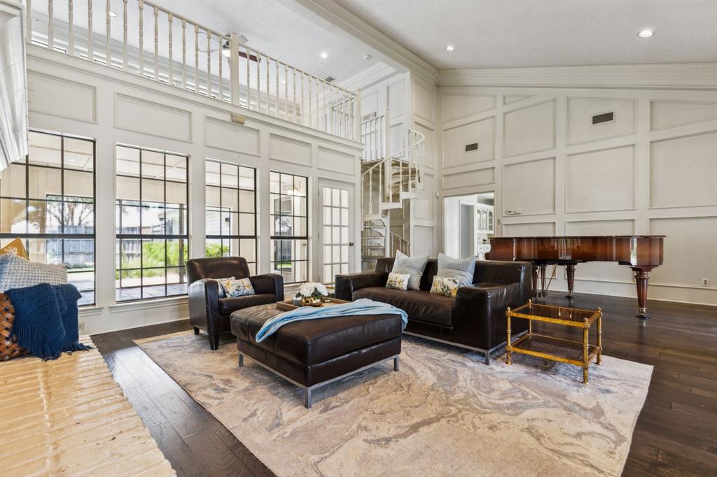 a bedroom with furniture and large windows