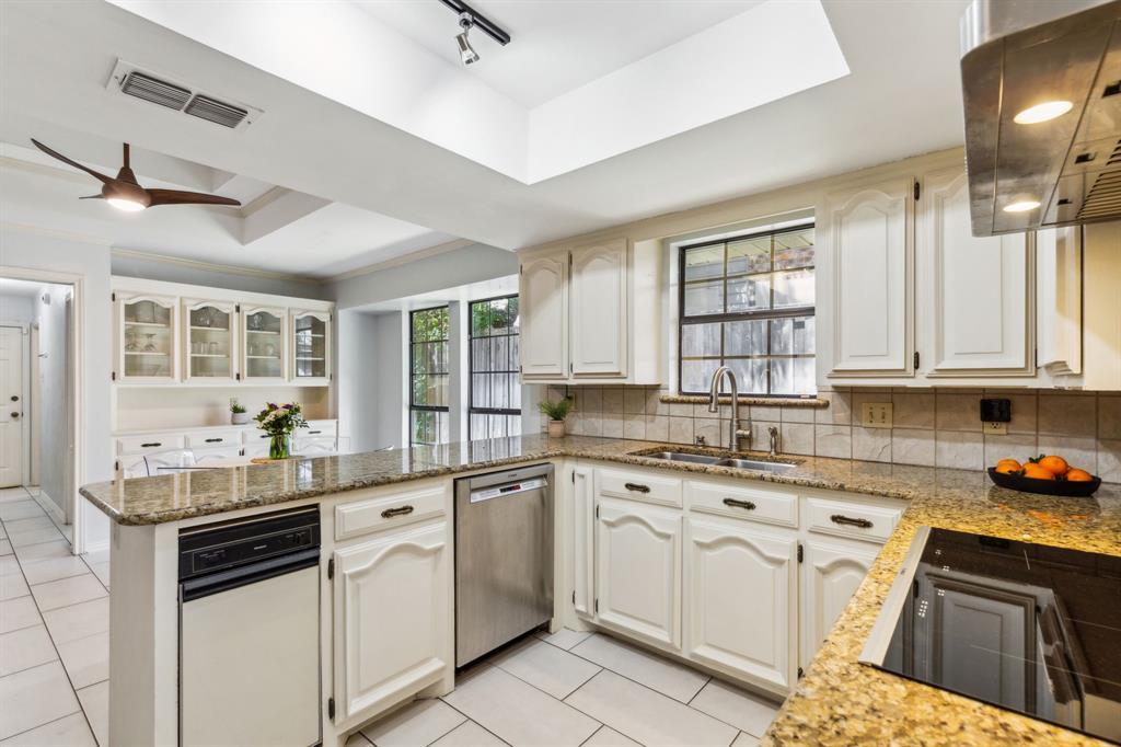 4130 High Star Lane Dallas, TX 75287 - Photo 14 of 38 a kitchen with white cabinets and white appliances